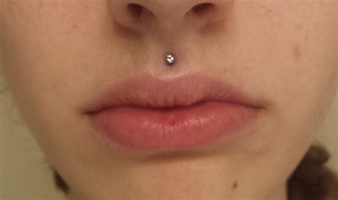 piercing above top lip.